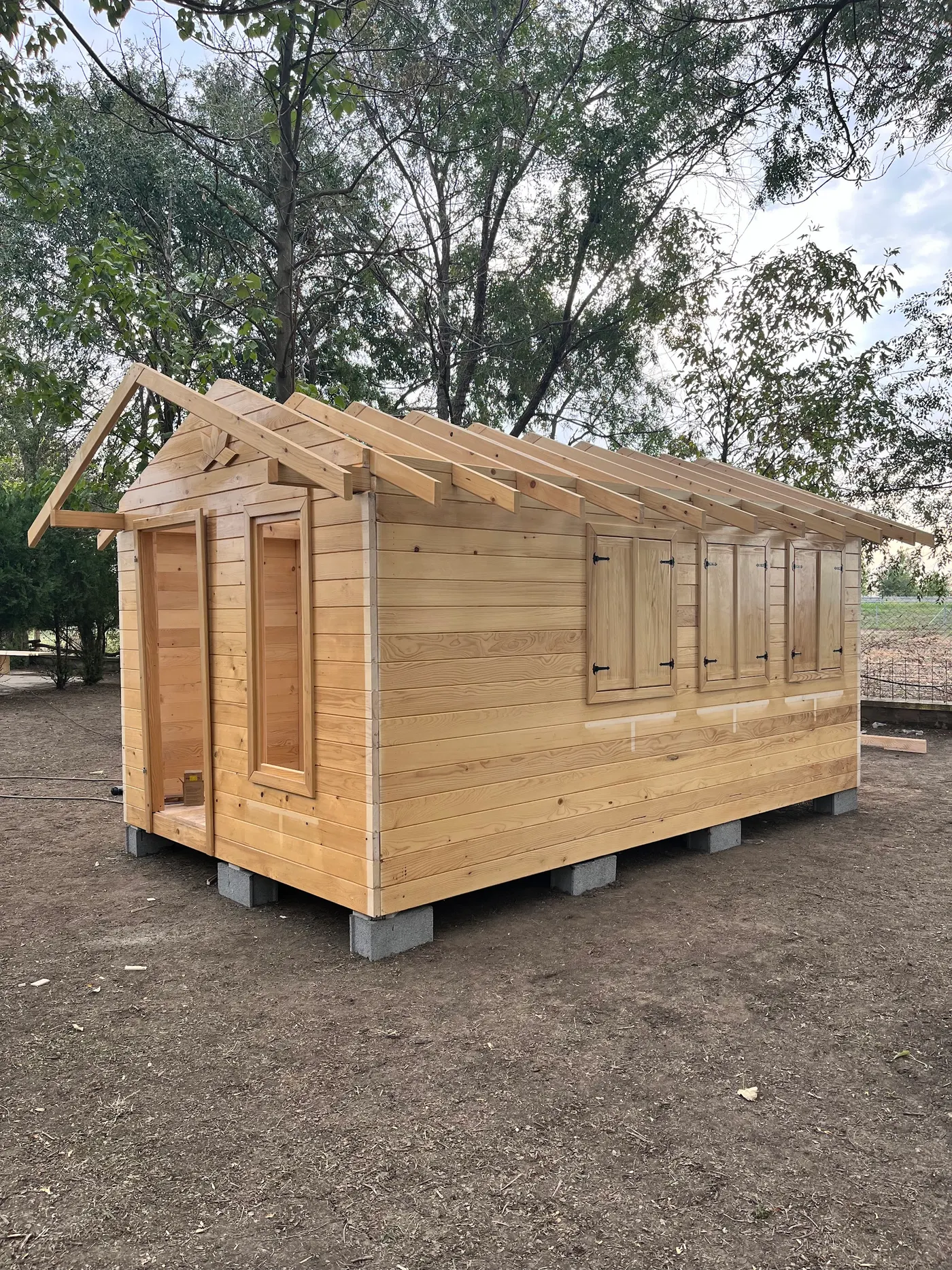 bright wooden garden cabin under trees after construction - Zmajevo - frame 13